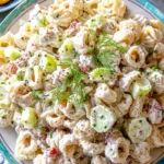 Colorful cold pasta salad with fresh vegetables and dressing