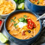 Bowl of creamy Southwest Chicken Soup garnished with herbs and spices