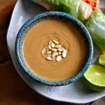 Bowl of homemade easy Thai peanut sauce with ingredients
