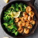 Garlic Butter Shrimp and Broccoli served on a plate, garnished with herbs