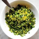 Fresh gremolata made with parsley, garlic, and lemon zest served on a plate.