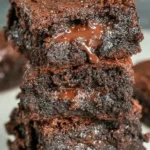 Delicious Greek yogurt brownies topped with cocoa and nuts.