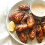Delicious jerk chicken wings served with spicy dipping sauce