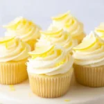 Homemade lemon cupcakes with frosting and lemon slices on top