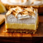 Homemade lemon meringue pie topped with fluffy meringue and lemon zest