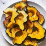 Deliciously roasted acorn squash served with herbs and spices.