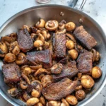 Seared mushroom steak garnished with herbs, showcasing a delicious vegetarian dish.