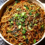 Plate of homemade Sesame Garlic Noodles with fresh herbs