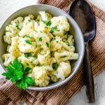 Simple steamed cauliflower with herbs in a bowl