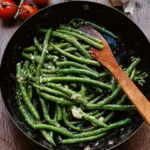 Skillet cooked garlic butter green beans garnished for a tasty side dish.