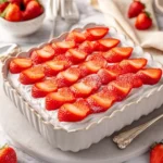 Delicious homemade Strawberry Icebox Cake topped with fresh strawberries and whipped cream