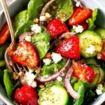 Strawberry Spinach Salad with Poppy Seed Dressing served in a bowl