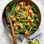 Colorful teriyaki stir fry with vegetables and chicken in a bowl
