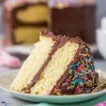 Delicious vanilla cake topped with creamy chocolate frosting