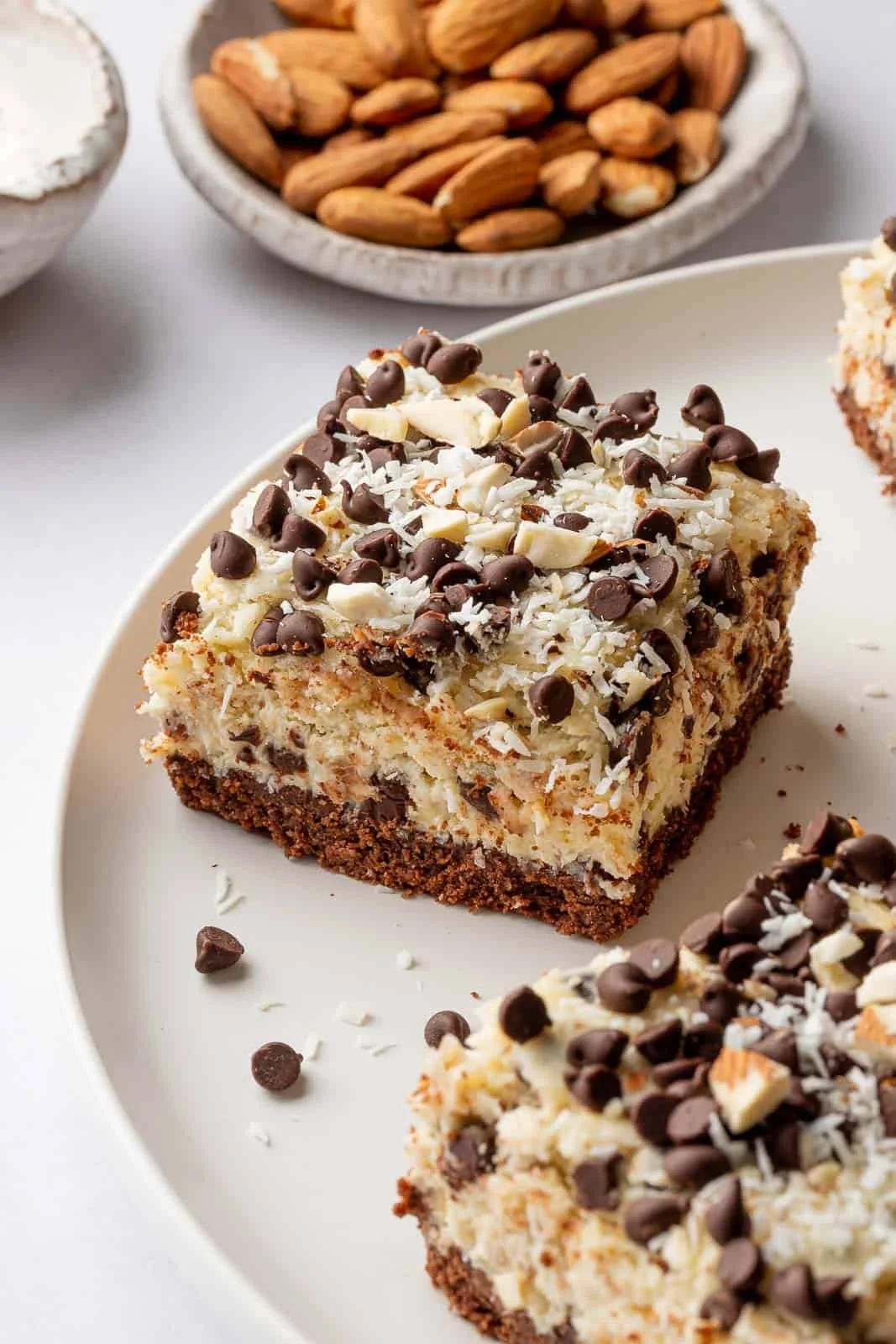 Delicious Almond Joy Cheesecake Bars with chocolate and coconut toppings.