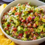 Bowl of vibrant avocado salsa with fresh ingredients