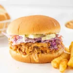 BBQ pulled chicken burger served with fresh toppings and sides
