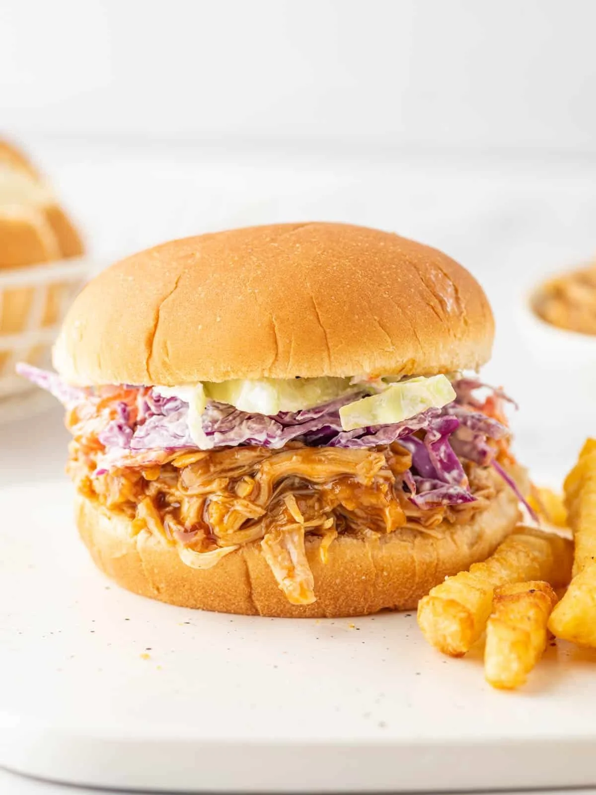 BBQ pulled chicken burger served with fresh toppings and sides