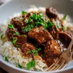 Delicious beef stew served with rice in a bowl