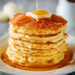 Delicious fluffy pancakes stacked high, ready to be enjoyed with syrup