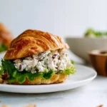 Delicious chicken salad sandwich served on fresh bread with lettuce and tomatoes.