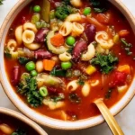 A bowl of classic Italian minestrone soup filled with fresh vegetables and beans.