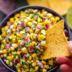 Delicious copycat Chipotle corn salsa in a bowl with fresh ingredients