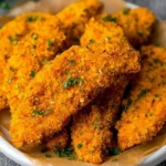 Crispy Cornflake Chicken Tenders plated with dipping sauce