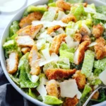 Crispy Chicken Caesar Salad with greens, croutons, and dressing