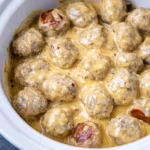Crockpot Swedish meatballs served on a plate with gravy and parsley garnish