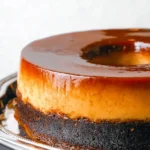 Decadent flan cake topped with chocolate, showcasing a rich dessert experience.