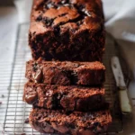 Double Chocolate Zucchini Bread slices with chocolate chips on a white plate