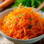 Fresh and colorful easy carrot salad with dressing in a bowl