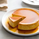 Delicious homemade flan decorated with caramel sauce on a white plate