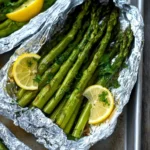 Delicious grilled asparagus in foil on a barbecue grill.