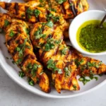 Delicious grilled chicken tenders served on a plate with fresh vegetables