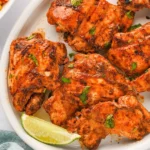 Delicious grilled roast chicken garnished with herbs and spices