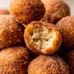 Freshly made homemade cinnamon sugar donut holes on a plate