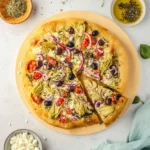 Delicious homemade Mediterranean pizza topped with fresh vegetables and herbs.