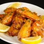 Delicious Honey Lemon Pepper Wings garnished with lemon slices