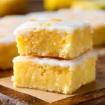 Delicious lemon brownies topped with icing on a plate