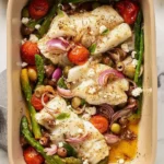 Delicious Mediterranean Cod served with fresh vegetables and herbs.
