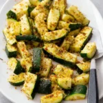 Freshly baked Parmesan Roasted Zucchini slices drizzled with olive oil