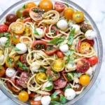 Pasta salad with garlic marinated tomatoes and fresh ingredients