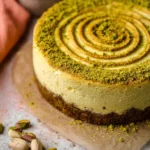 Slice of delicious pistachio cheesecake topped with crushed pistachios