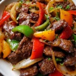 Savory pepper steak with bell peppers and onions on a plate