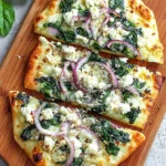 Spinach and Feta Flatbread Pizza topped with fresh ingredients and cheese