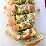 Spinach artichoke stuffed bread served warm, perfect for appetizers