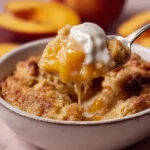 Delicious grilled peach cobbler served in a rustic dish.