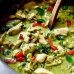 Plate of Thai Ginger Chicken served with rice and fresh herbs